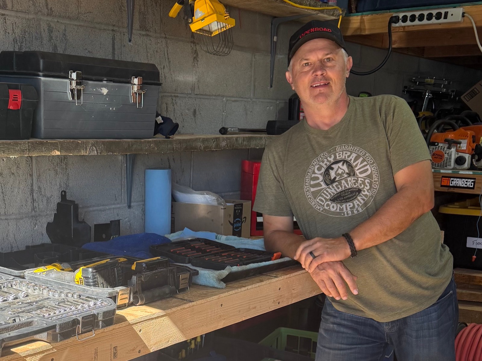 Jim leaning on his workbench in the shop
